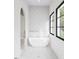 Bright bathroom with a standalone soaking tub, stylish tile flooring and views to the outdoors at 3601 Alamance Dr, Raleigh, NC 27609