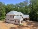 In-progress build of a two-story home displaying the exterior framing and roof structure amid natural surroundings at 3601 Alamance Dr, Raleigh, NC 27609