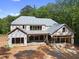 New home under construction with visible framing, roofing materials, and construction site surroundings at 3601 Alamance Dr, Raleigh, NC 27609
