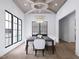 Formal dining room boasts coffered ceilings, hardwood floors, decorative chandelier and lots of natural light at 3601 Alamance Dr, Raleigh, NC 27609