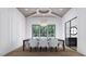 Formal dining room boasts coffered ceilings, hardwood floors, decorative chandelier and lots of natural light at 3601 Alamance Dr, Raleigh, NC 27609