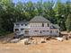 Exterior aerial view showcasing the home's structure and surrounding landscape during construction at 3601 Alamance Dr, Raleigh, NC 27609