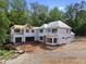 Two-story home under construction features a full unfinished basement and a charming wooded lot at 3601 Alamance Dr, Raleigh, NC 27609