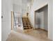 Unfinished foyer featuring a wooden staircase and access to multiple rooms at 3601 Alamance Dr, Raleigh, NC 27609