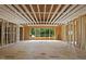 The wood framing shows the placement of a picture window that faces a green tree covered lot at 3601 Alamance Dr, Raleigh, NC 27609