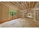 Unfinished interior showcasing stud walls and a large window with green outdoor views at 3601 Alamance Dr, Raleigh, NC 27609