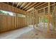 Partially constructed interior space with framed walls, multiple windows, and natural light at 3601 Alamance Dr, Raleigh, NC 27609