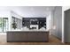 Modern open concept kitchen boasts a center island with marble counters, custom cabinets, and stainless appliances at 3601 Alamance Dr, Raleigh, NC 27609