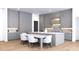 Modern kitchen with gray cabinets, center island with marble counters, stainless appliances, and dining area at 3601 Alamance Dr, Raleigh, NC 27609