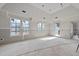 Spacious, unfinished living room with many windows providing natural light at 3601 Alamance Dr, Raleigh, NC 27609
