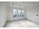 Unfinished living room featuring large windows for plenty of light at 3601 Alamance Dr, Raleigh, NC 27609
