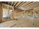 Spacious living room under construction features framed walls, plywood floor, and high ceiling at 3601 Alamance Dr, Raleigh, NC 27609
