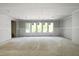 Large, unfinished living room featuring multiple windows and drywall at 3601 Alamance Dr, Raleigh, NC 27609