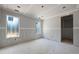 A bare living room is illuminated by natural light streaming through two windows at 3601 Alamance Dr, Raleigh, NC 27609