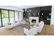 Living room features modern furniture, hardwood floors, fireplace, custom built-ins, and lots of natural light at 3601 Alamance Dr, Raleigh, NC 27609