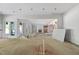 Under-construction living room showing open layout, fireplace, and ample natural light at 3601 Alamance Dr, Raleigh, NC 27609