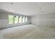 Bright, unfinished living room with large windows providing ample natural light at 3601 Alamance Dr, Raleigh, NC 27609