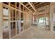 View of the wood framing and the electrical and plumbing of the unfinished living room at 3601 Alamance Dr, Raleigh, NC 27609