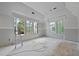 Bright unfinished living room with lots of windows at 3601 Alamance Dr, Raleigh, NC 27609