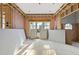 Unfinished living room with pink insulation, wood framing and multiple windows at 3601 Alamance Dr, Raleigh, NC 27609