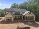 Back exterior view of a house under construction, soon to be a stylish home with a covered patio at 3601 Alamance Dr, Raleigh, NC 27609