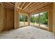 Bright sun room during construction with large windows offering lush greenery views at 3601 Alamance Dr, Raleigh, NC 27609