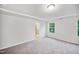 Spacious bedroom features neutral carpet, natural lighting, and a view into the bathroom at 4108 Shadbush St, Raleigh, NC 27616