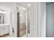 Modern glass shower with tiled surround and a rain shower head in bathroom with white vanity at 4108 Shadbush St, Raleigh, NC 27616