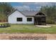 Spacious backyard featuring a screen porch, stone patio, and ample green space for outdoor enjoyment at 4622 Durham Rd, Wake Forest, NC 27587