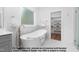 Luxurious bathroom with freestanding tub, elegant fixtures, and walk-in closet at 4622 Durham Rd, Wake Forest, NC 27587