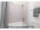 Clean bathroom featuring a shower/tub with gray tiling and a decorative shower curtain at 4622 Durham Rd, Wake Forest, NC 27587