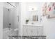 Clean bathroom featuring a combination shower and tub, with bright white cabinets and decor at 4622 Durham Rd, Wake Forest, NC 27587