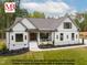 Stunning exterior of home with lovely landscaping, a covered porch, and a crisp white facade at 4622 Durham Rd, Wake Forest, NC 27587