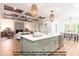 Open concept kitchen features an island with white countertop overlooking the dining area and living room at 4622 Durham Rd, Wake Forest, NC 27587