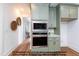 Kitchen detail showing stainless steel microwave and oven set in light green cabinets next to the hallway at 4622 Durham Rd, Wake Forest, NC 27587
