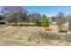 Grassy lot featuring bare trees and the surrounding terrain with a home under construction in the background at 4622 Durham Rd, Wake Forest, NC 27587