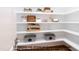 Well-organized walk-in pantry featuring white shelving and various storage containers at 4622 Durham Rd, Wake Forest, NC 27587