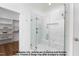 Modern bathroom shower featuring a glass enclosure, marble tile, and a built-in niche at 4622 Durham Rd, Wake Forest, NC 27587