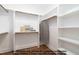 Spacious walk-in closet with custom shelving and wooden closet rods for ample storage at 4622 Durham Rd, Wake Forest, NC 27587