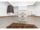 Organized walk-in closet with ample shelving, hanging space, and hardwood floors at 4622 Durham Rd, Wake Forest, NC 27587