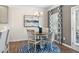 Cozy dining area boasts a round table, chandelier, blue rug and bright natural light at 507 Olivia Crossing Ct # 20, Four Oaks, NC 27524