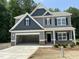 Beautiful two-story home featuring a two-car garage, craftsman details, and a well-manicured lawn in a suburban setting at 507 Olivia Crossing Ct # 20, Four Oaks, NC 27524