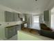 Spacious kitchen with gray cabinets, central island and natural light, perfect for cooking and entertaining at 507 Olivia Crossing Ct # 20, Four Oaks, NC 27524