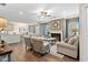 Cozy living room featuring a fireplace, ceiling fan, hardwood floors and blue accent pillows at 507 Olivia Crossing Ct # 20, Four Oaks, NC 27524