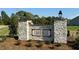 Stone community entrance sign for Chamblee, surrounded by landscaping at 507 Olivia Crossing Ct # 20, Four Oaks, NC 27524