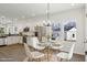 Dining area featuring modern chandelier and open-concept view of kitchen at 614 Gilmer St, Burlington, NC 27217