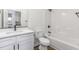 Modern bathroom with white vanity, quartz counters, and a shower-tub combination at 620 Gilmer St, Burlington, NC 27217