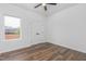 This bedroom features wood floors, a ceiling fan and a window providing natural light at 620 Gilmer St, Burlington, NC 27217
