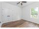 This bedroom features wood-look flooring, a large window, and a double-door closet at 620 Gilmer St, Burlington, NC 27217