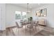 Modern dining room with table, chairs, chandelier, and lots of natural light at 620 Gilmer St, Burlington, NC 27217